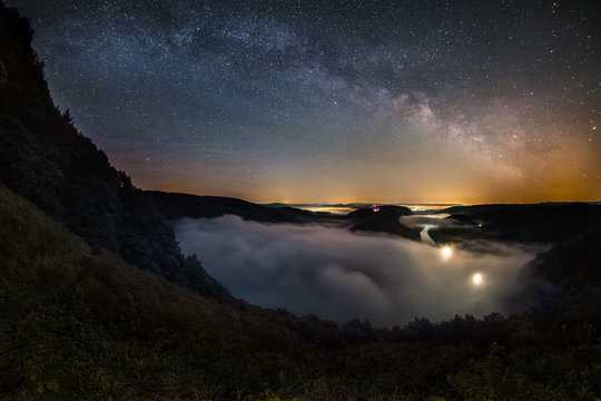 Astro Landscape with the Milky Way and the Saar Loop as seen from the viewpoint Cloef at Orscholz near Mettlach in Germany.