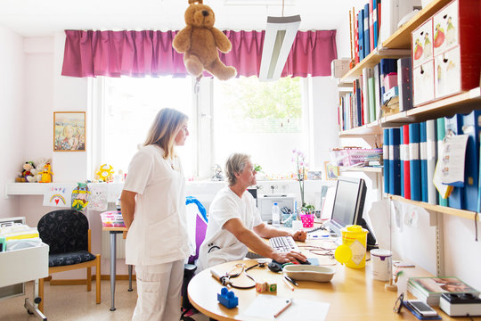 Doctor and nurse looking at computer monitor