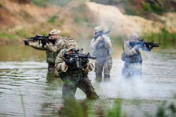 special forces soldiers with weapon take part in military maneuver. war, army, technology and people concept.