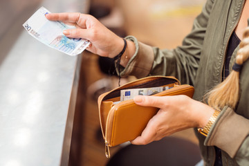 Woman paying with cash at bar