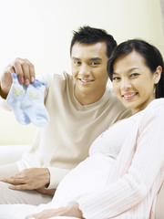 couple showing baby booties to camera