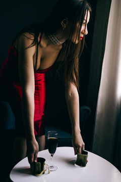 Sexy gorgeous beautiful girl standing in  room with red dress, elegant hair-style and make-up