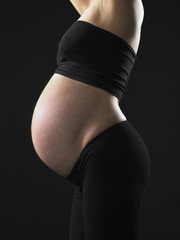 Fototapeta premium profile of pregnant woman showing her tummy