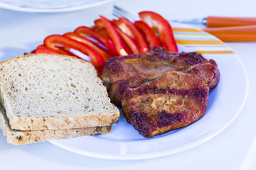 Grilled meat with bread and seasonings