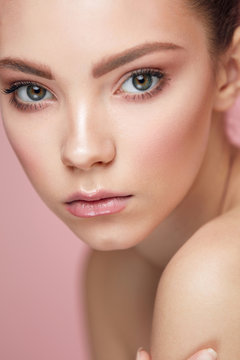 Facial Beauty Makeup. Woman With Fresh Face On Pink Background