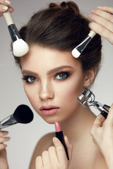 Fashion Beauty. Girl With Glamorous Makeup And Brushes Near Face