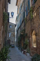 Fototapeta na wymiar Beautiful narrow street in the small magical and old village of Pienza, Val D'Orcia Tuscany - Italy