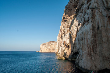 Fototapeta na wymiar Capo Caccia - rocks that rise straight from the sea on the island of Sardinia.