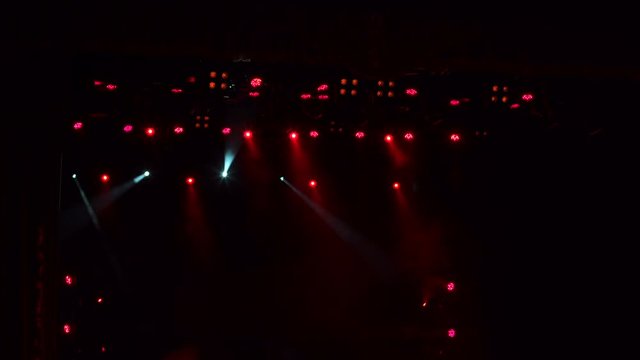 Red stage lights, light show at the concert. Light show testing before the concert.