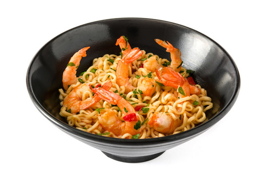 Noodles and shrimps with vegetables in black bowl isolated on white background

