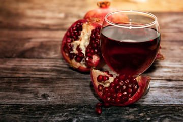 Glass of pomegranate juice and pomegranate fruit