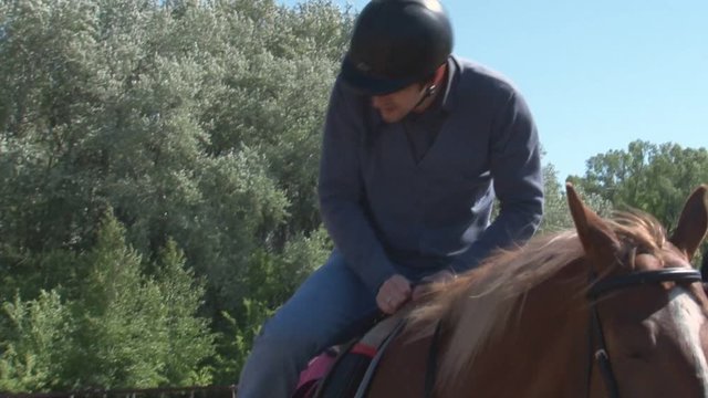 Boy learns horse riding