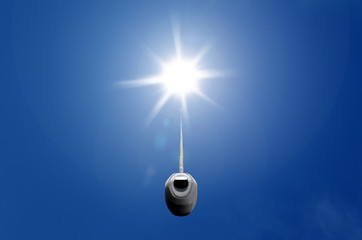 Renewable energy, illustrated by lamp switch connected to the sun in blue sky