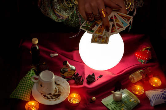 Woman soothsayer holding tarot cards for future reading