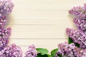 Vintage background with lilacs. Beautiful vintage styled stock photo with lilac flowers on wooden background. Copy space for your text / item.