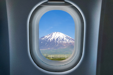 Naklejka premium Beatiful Fuji mountain view from airplane window. Concept picture