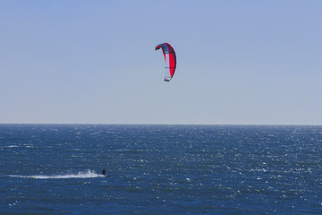 Kitesurfing silhouette at sunset.