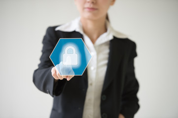 Double exposure of professional businessman touching security hexagonal polygon button on a digital interface and city of business background in business and security technology choices concept