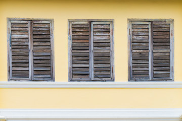 Old wood window on brown cement wall Sino-Portuguese style architecture at Phuket Thailand  - can use to display or montage on product