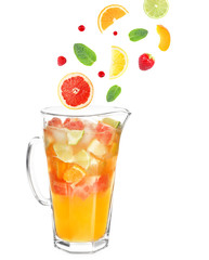 Falling fruit slices and berries into glass jug with lemonade on white background. Recipe for summer drink