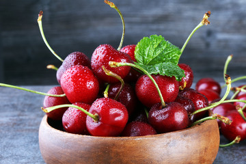 Cherry bowl with sweet cherries with leaf