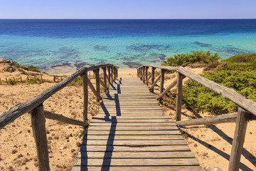 The most beautiful beaches of Italy. Campomarino dune park: fence between sea dunes,Taranto...