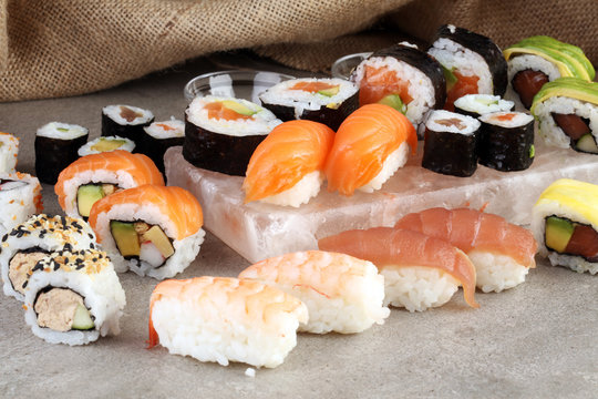 close up of sashimi sushi set with chopsticks and soy - sushi roll with salmon and sushi roll with smoked eel, selective focus.