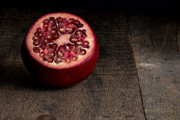 Rustic pomegranate on wood 