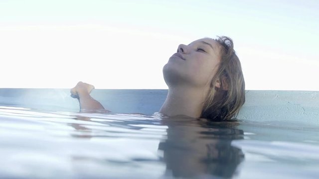 Woman relaxing in swimming pool