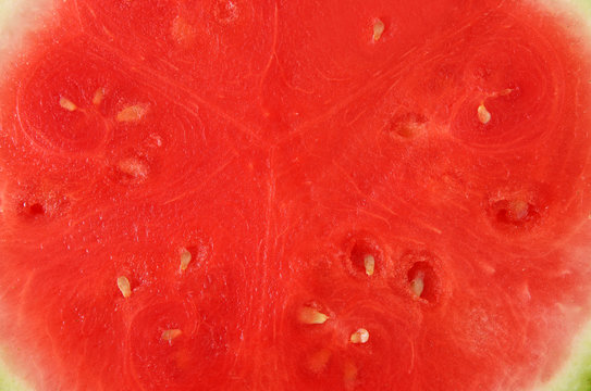 Natural background of fresh, red sliced watermelon