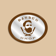 A vector illustration depicting a man's face with a beard and glasses over two crossed razors. Logo of the men's hairdresser.