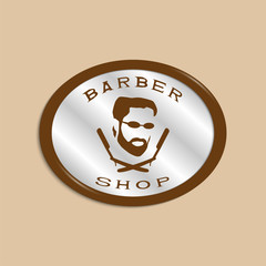 A vector illustration depicting a man's face with a beard and glasses over two crossed razors. Logo of the men's hairdresser.