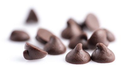 Dark chocolate chips isolated on white background.
