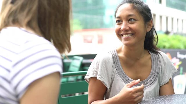 Women chatting at outdoor cafe