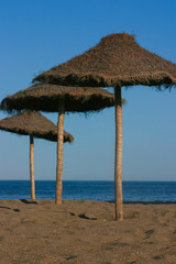 Straw umbrellas on a beautiful tropical beach