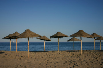Straw umbrellas on a beautiful tropical beach