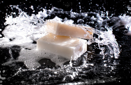 Soap Bar With Splashes Of Water On The Dark Background