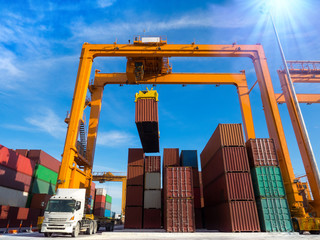 The RTG(Rubber Tried Gantry Cranes) pick up full loaded containers on truck at industrial port and container yard for delivery to customers