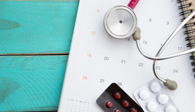 stethoscope and drugs on calendar, medical concept