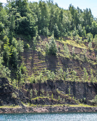 South wall of abandoned flooded quarry taken from base