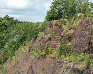 Large carved steps in abandoned flooded quarry wall