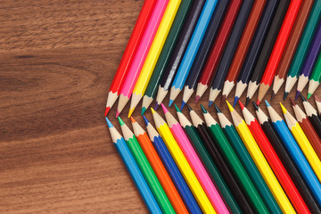 Set of colored pencils, wooden background