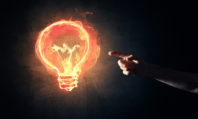 Concept of electricity or inspiration with burning light bulb an