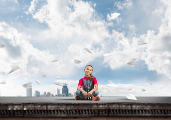 Concept of careless happy childhood with girl of school age smilling