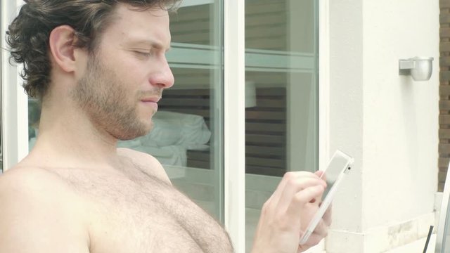 Man using smartphone while sunbathing
