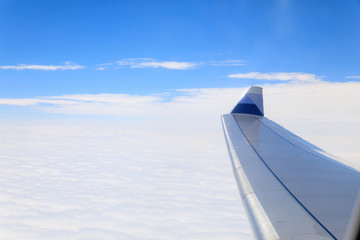 Fototapeta na wymiar View of beautiful cloud and wing of airplane from window - Travel concept