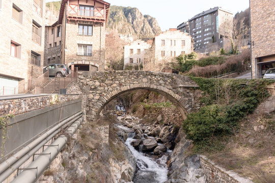 A mountainous fast river flows through the old city