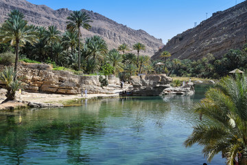 Clear water in wadi in Oman mountains - obrazy, fototapety, plakaty