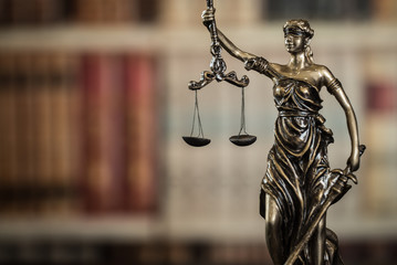 Lady Justice and law books in court