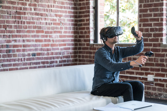 A caucasian man wearing a virtual reality headset.